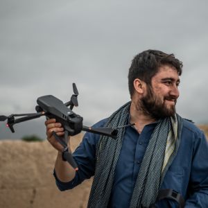 My picture with blue clothes and I have a drone in my hand.